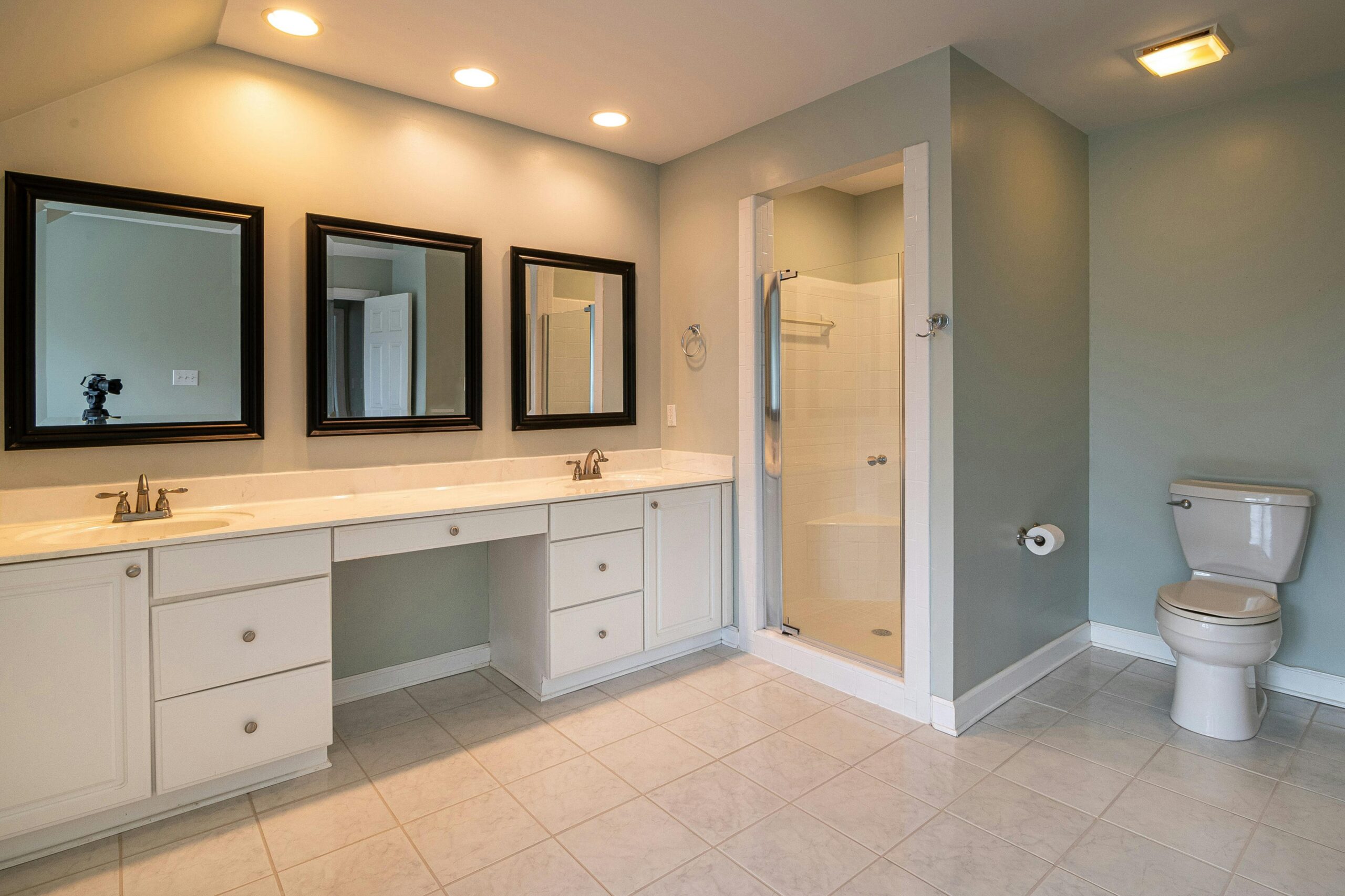 pexels-photo-3935352-3935352 Spacious contemporary bathroom with dual sinks and a shower panel.